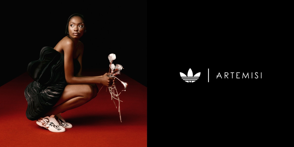 A person wearing black clothing sits on a red surface, holding a feathered object, with the Artemisi logo visible in the background.