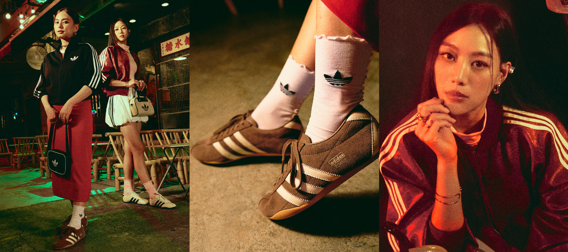 The image features two individuals in the foreground, one wearing a red jacket and the other in a black outfit, while in the background, a person's legs and feet are visible, wearing distinctive striped socks.