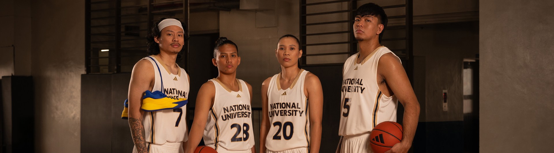 The image shows a group of four individuals wearing basketball uniforms with the text "National University" printed on them, standing together in what appears to be a basketball court or gymnasium setting.