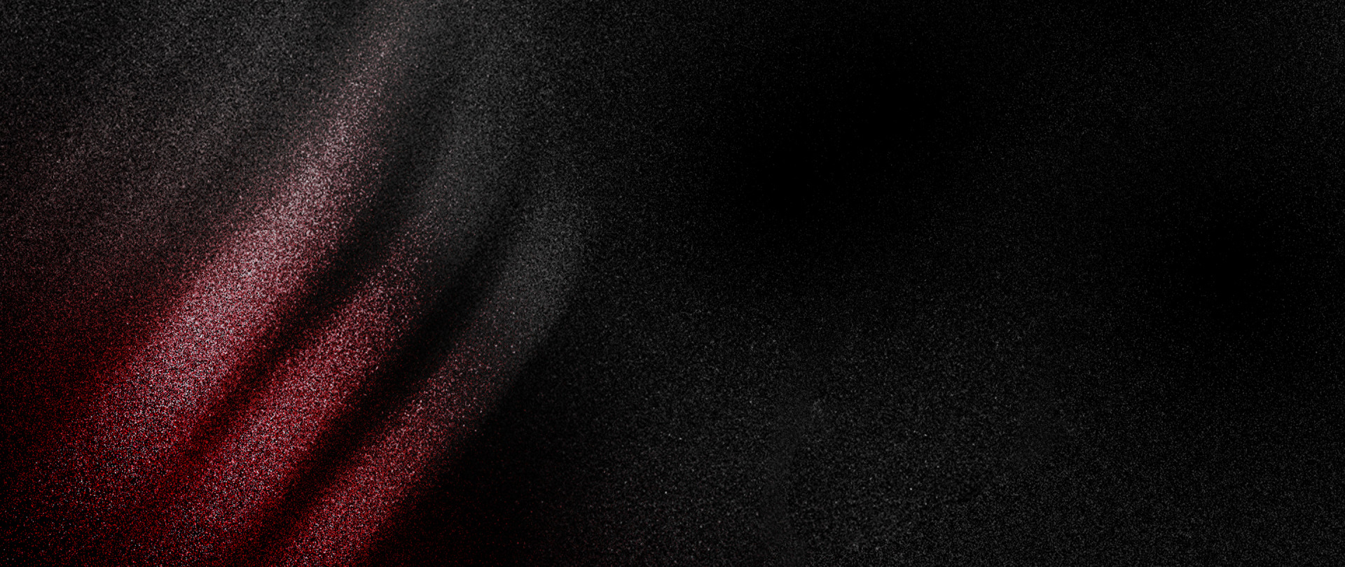 A dark, textured background with a vibrant red diagonal stripe cutting across the frame, creating a striking visual contrast.