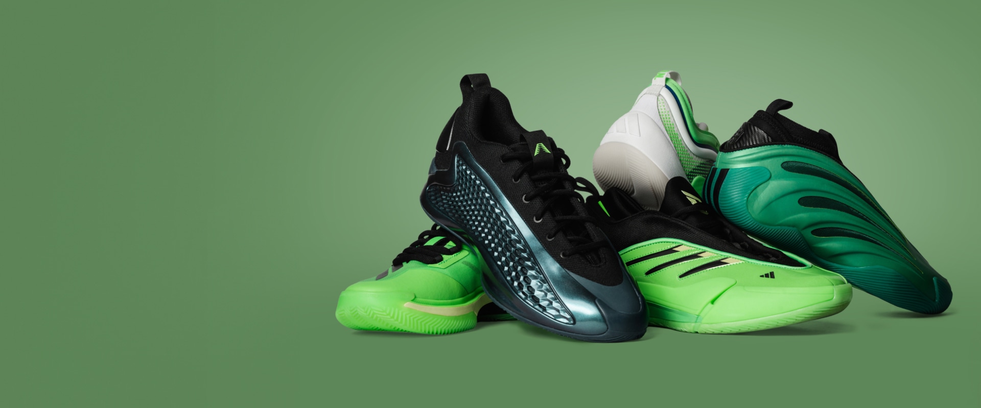 The image features a pair of vibrant green and black athletic shoes, with a textured pattern and sleek design, set against a solid green background.