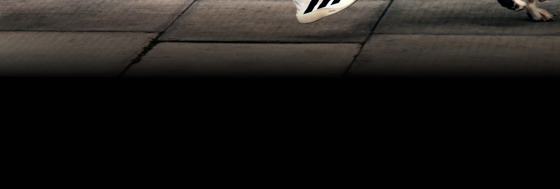 Two people are running along a pavement wearing the Evo SL.