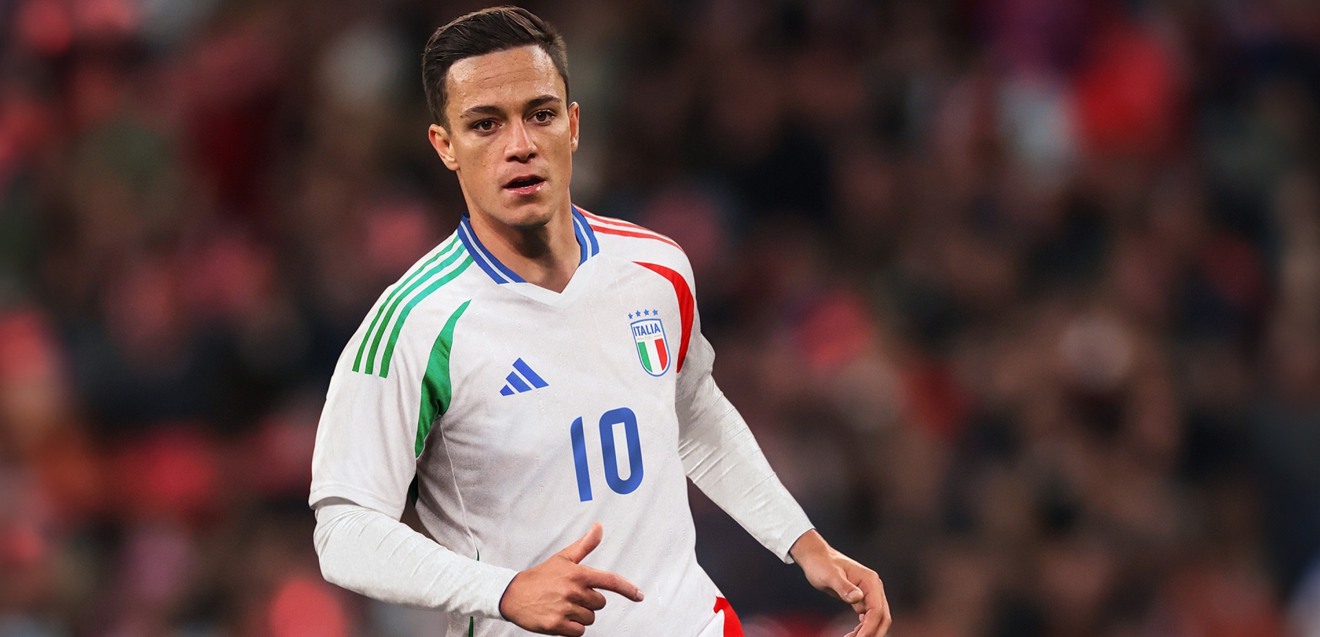 Visual composition featuring the new Italy EURO 2024™ AWAY Kit worn by a Player