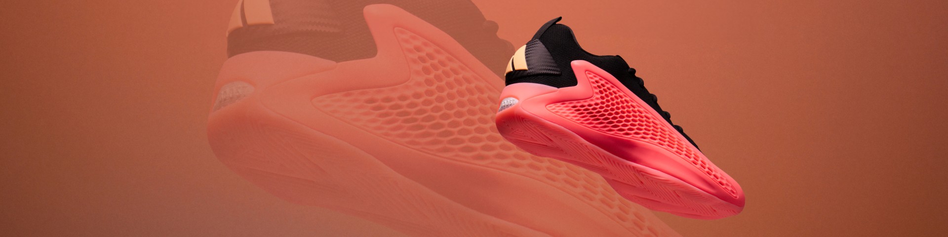 The image shows a close-up view of a pair of vibrant, neon-colored athletic shoes with a textured, mesh-like upper design against a warm, reddish-orange background.