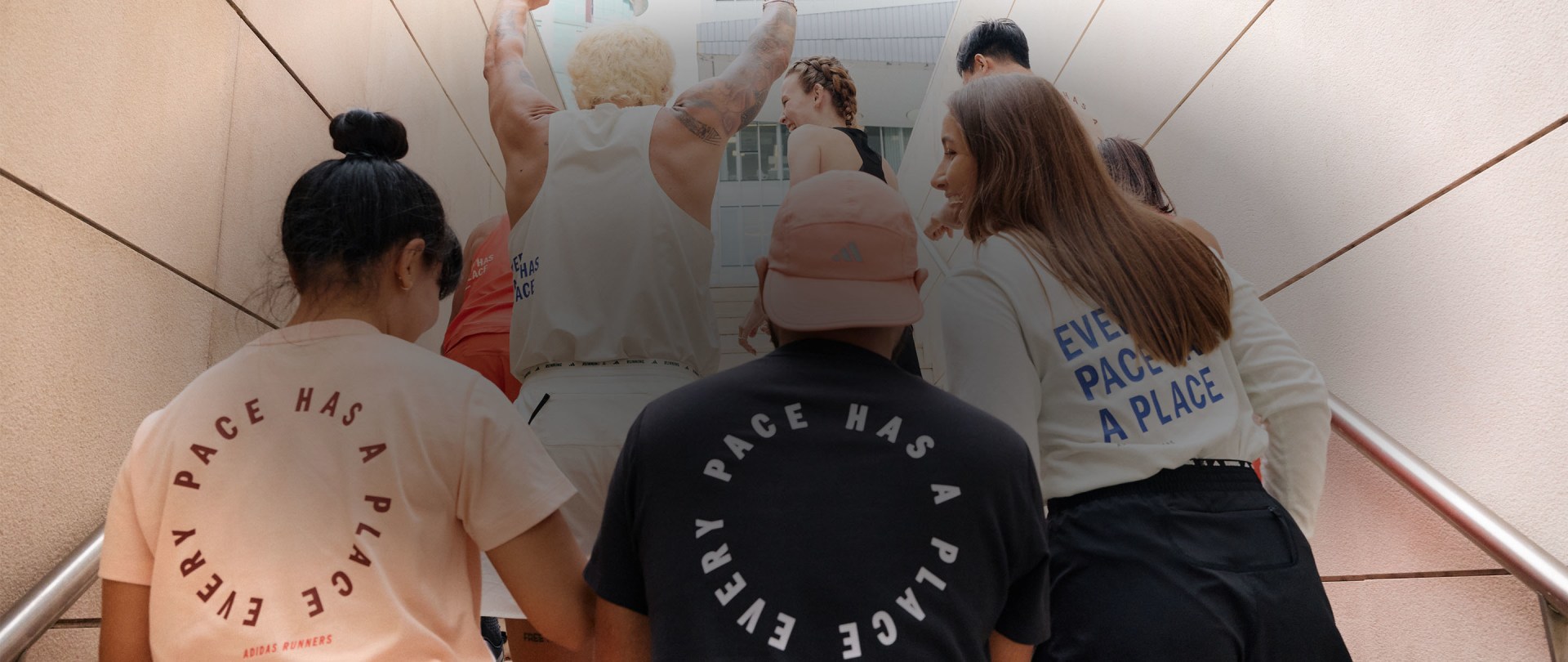 A group of people from behind walking up stairs and interacting with each other