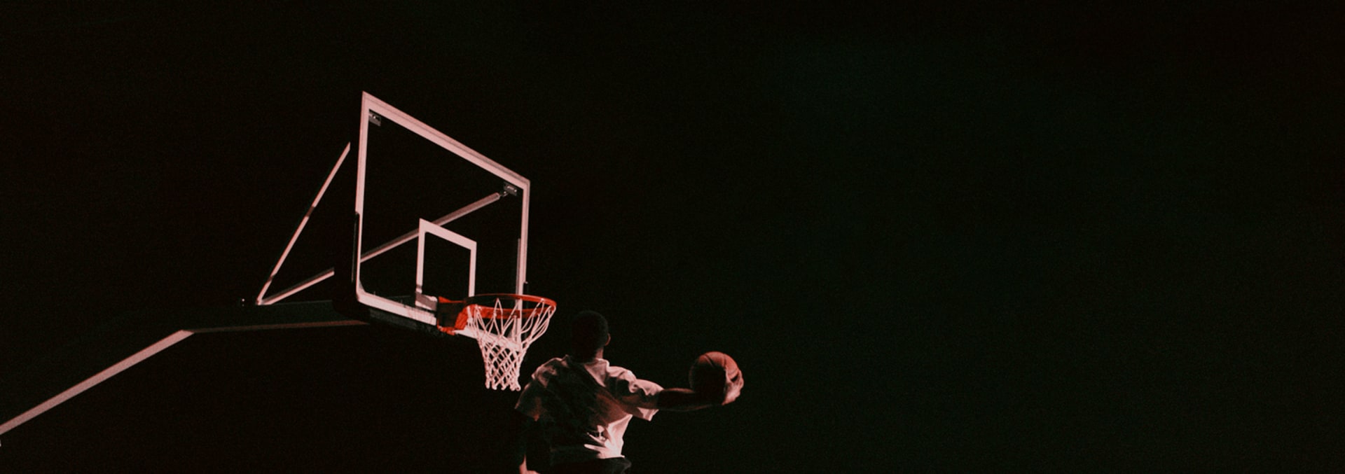 Anthony Edwards dunks a basketball on an indoor court, wearing a white adidas t-shirt, black adidas shorts and the Anthony Edwards 2 basketball sneaker.