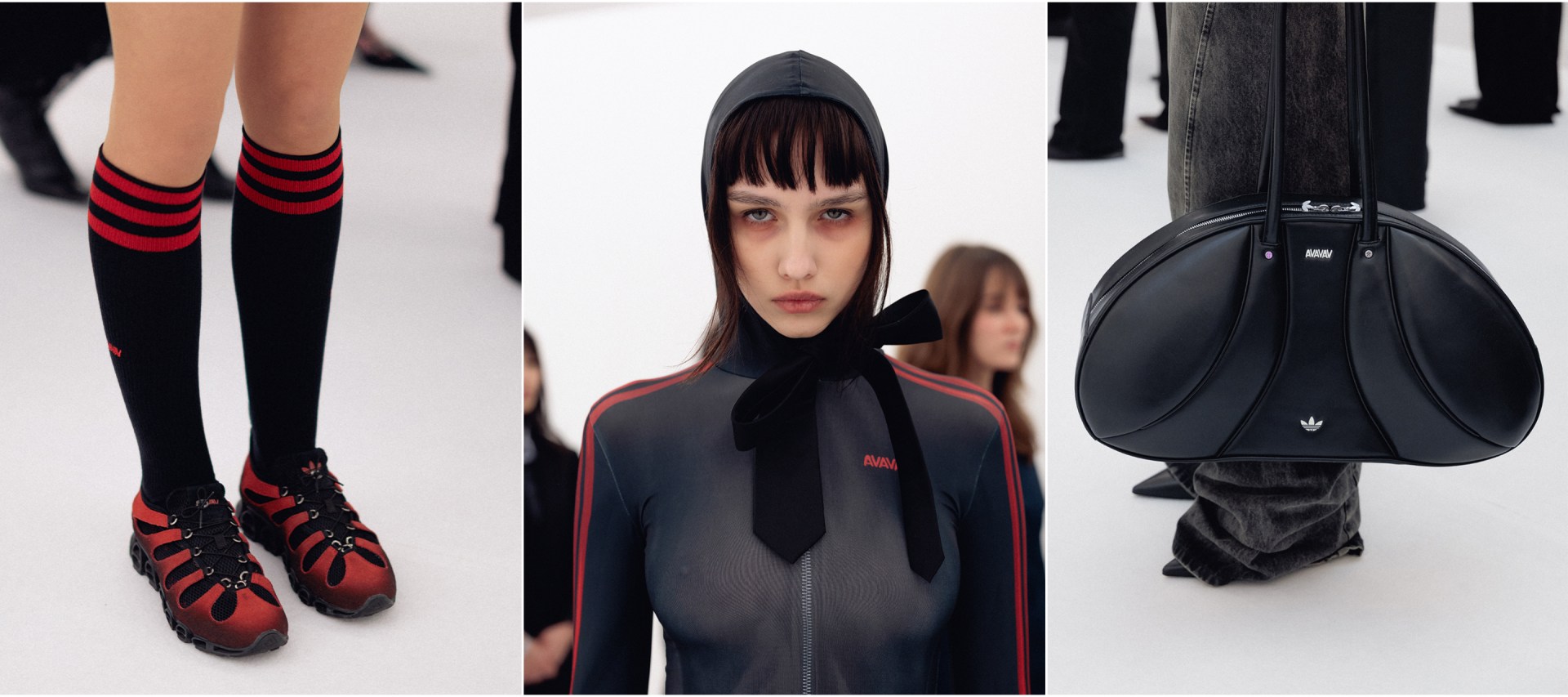 The image shows a person wearing a black hooded outfit with red accents, standing in a dark setting with a black backpack visible in the background.