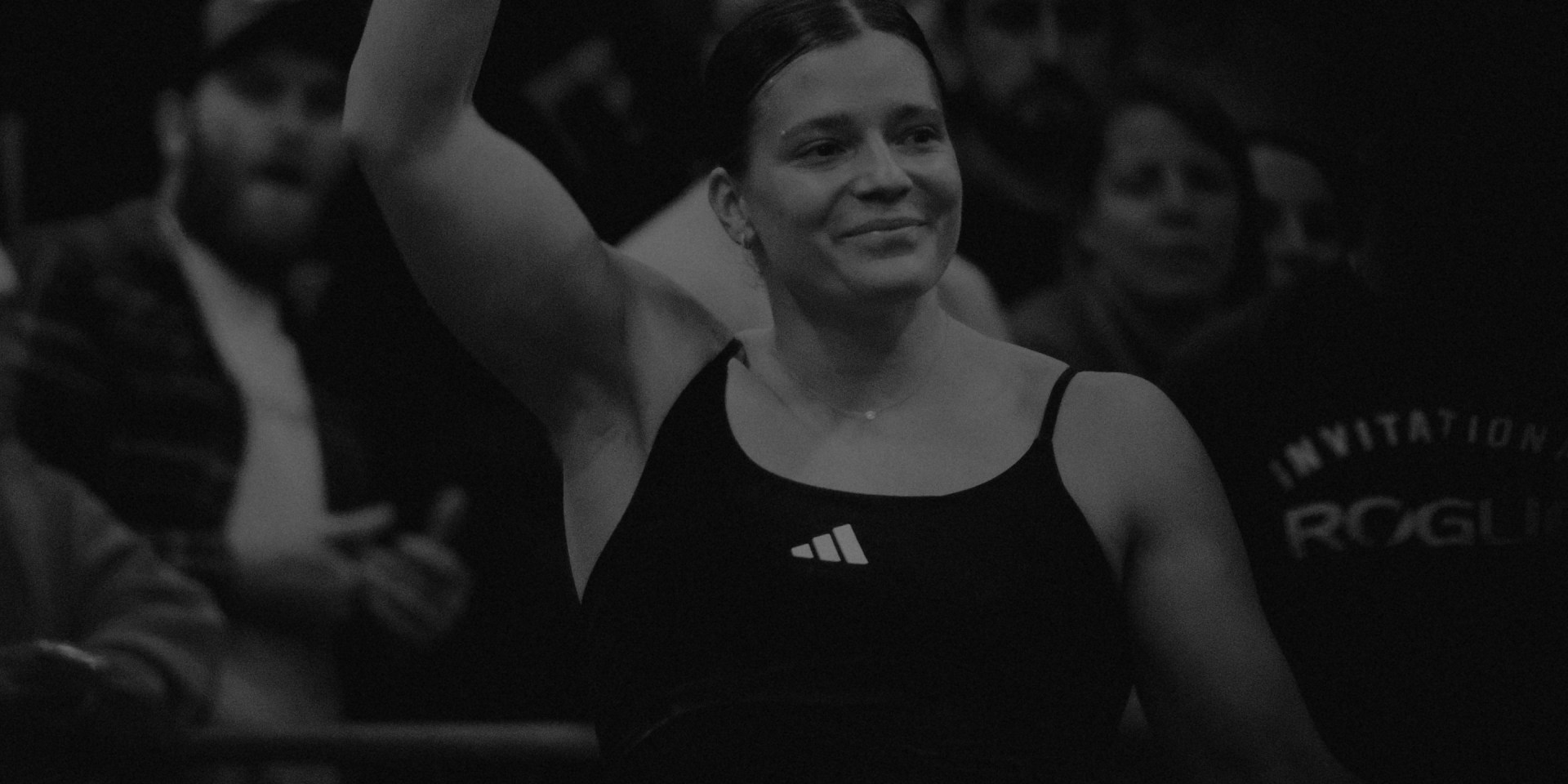 A black and white background image of Laura Horvath.