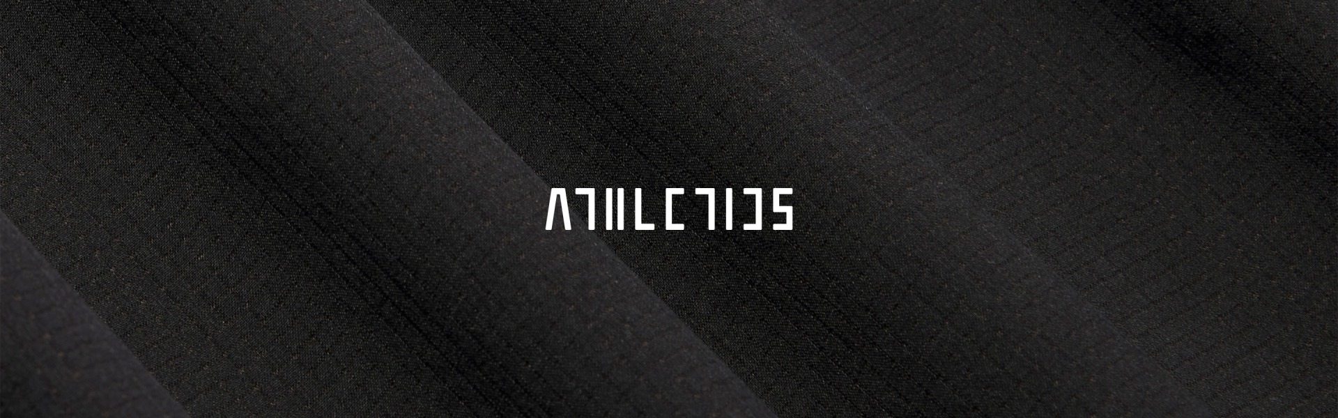 The word "ATHLETICS" in stylized white text is centered over a close-up of black textured fabric with soft folds.