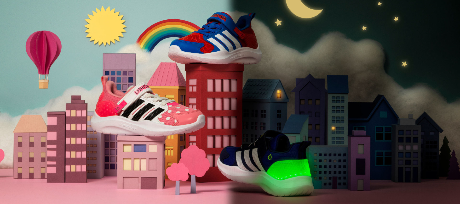 A colorful and whimsical scene featuring abstract shapes, buildings, and a large, stylized figure in the foreground against a night sky backdrop.