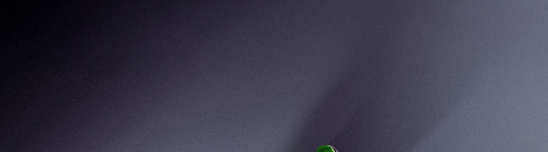 A single green object stands out against a dark, shadowy background.