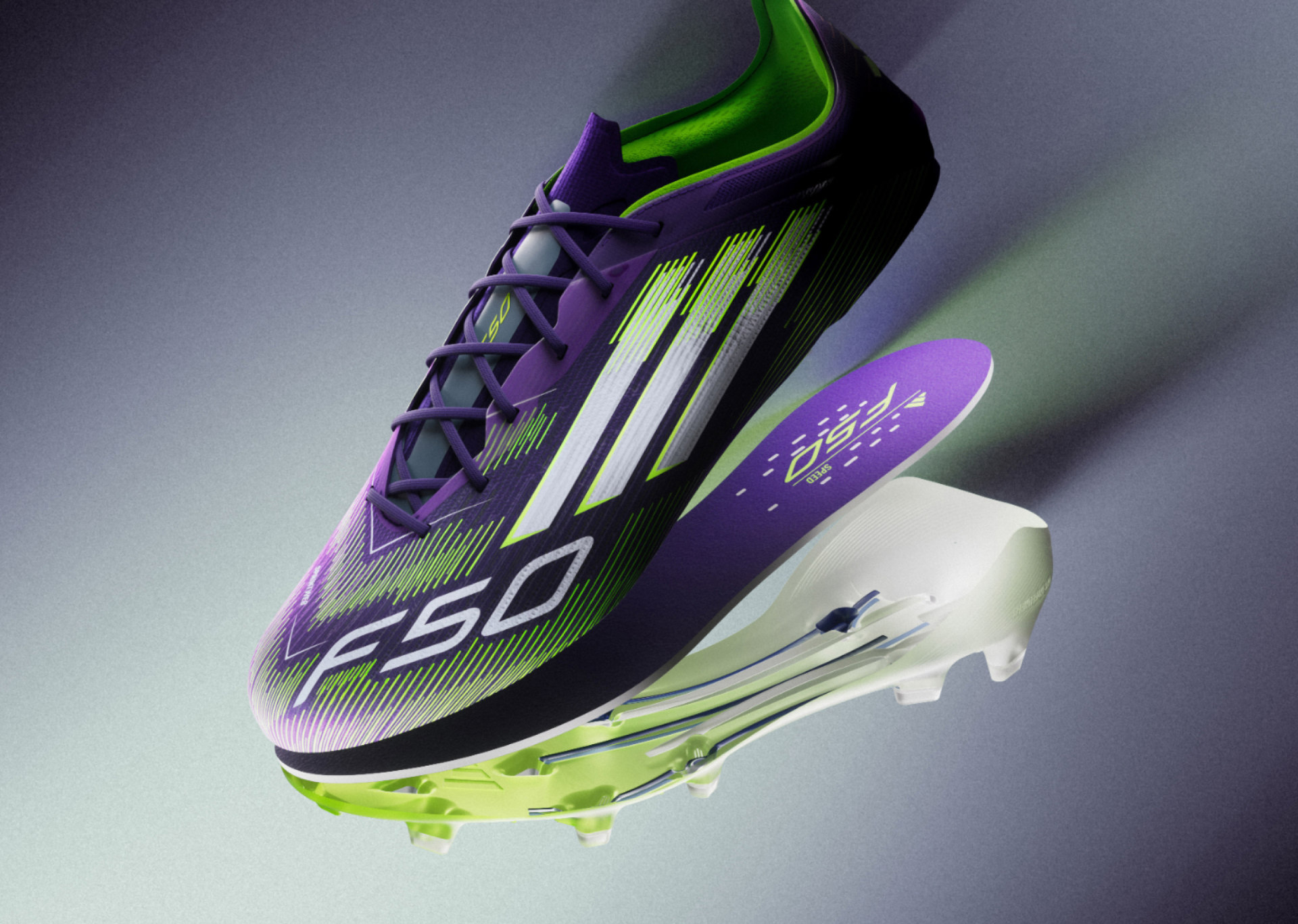 A vibrant purple and green soccer cleat with a sleek, aerodynamic design stands out against a blurred background.