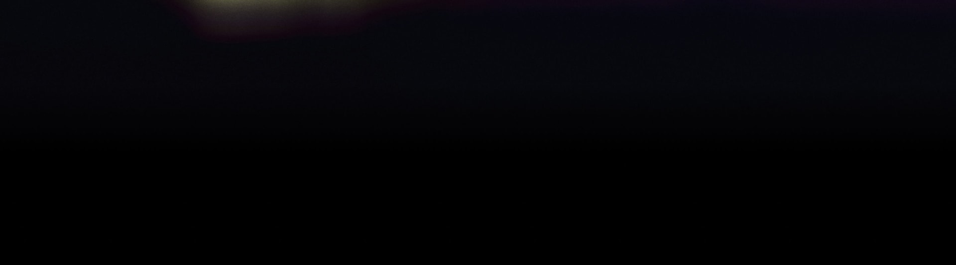 A completely dark and empty background with no visible elements or details.