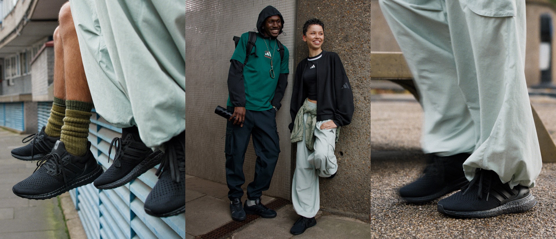 Two individuals, one wearing a green jacket and the other a black outfit, stand against a wall with various textiles and fabrics in the background.