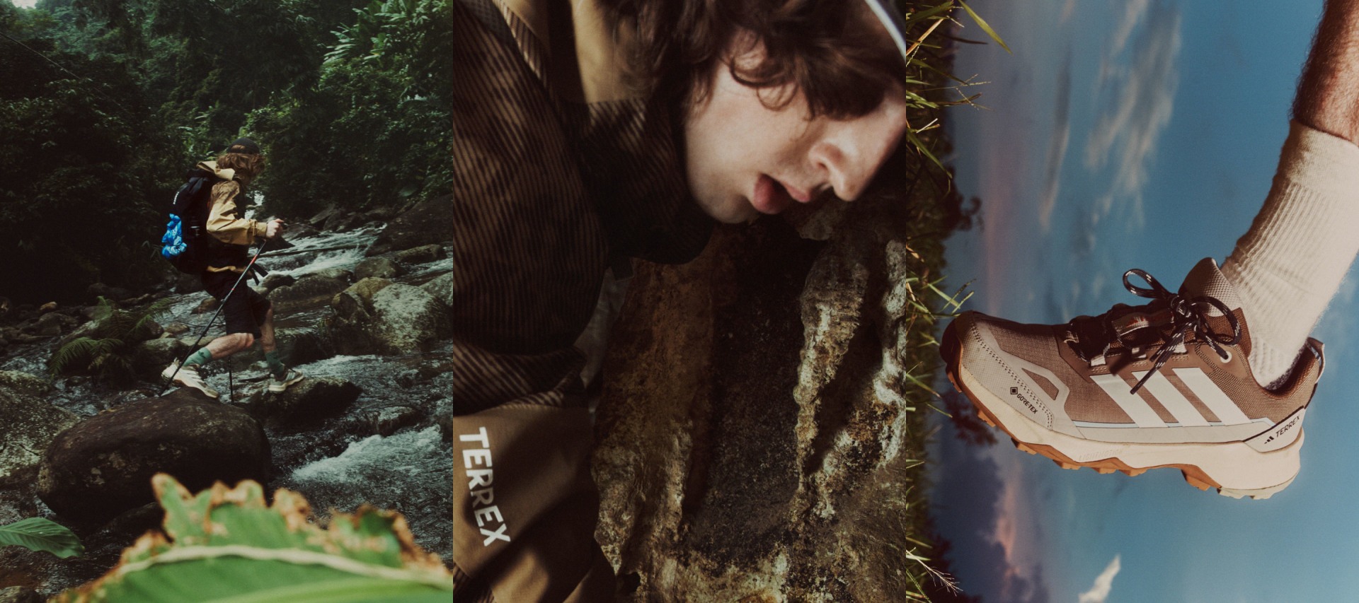 En persons ansigt er delvist tilsløret af langt, mørkt hår, med et stenet, skovdækket landskab og en vandmasse, der er synlig i baggrunden.