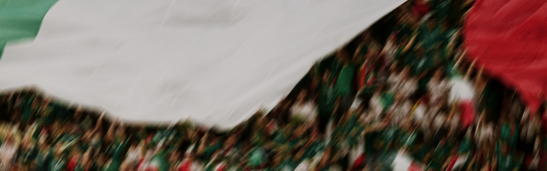 A blurred, abstract landscape with vibrant colors and shapes, creating a sense of movement and energy.