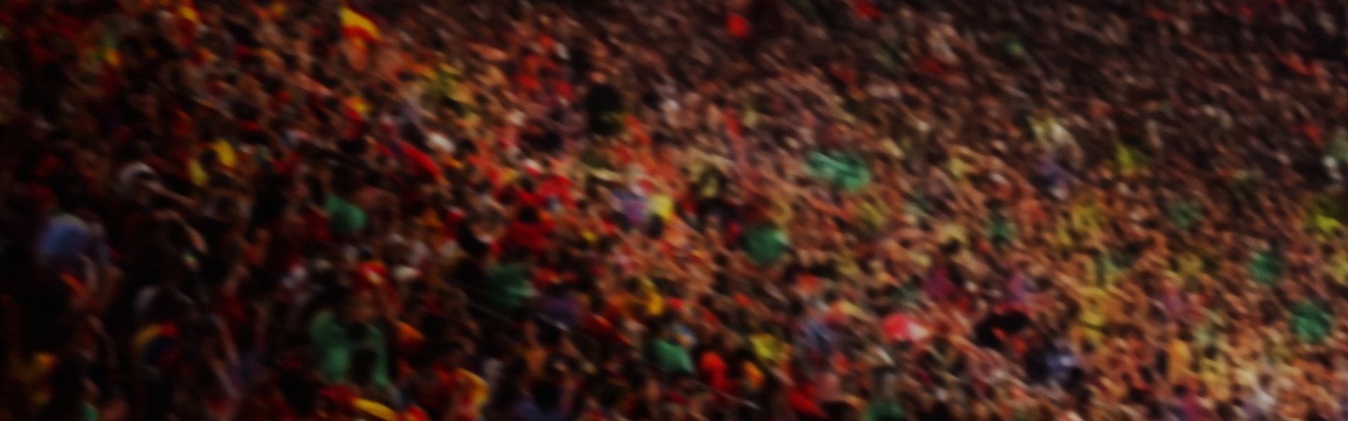 A vibrant, abstract background with a blurred, swirling pattern of various colors, including red, green, yellow, and blue.