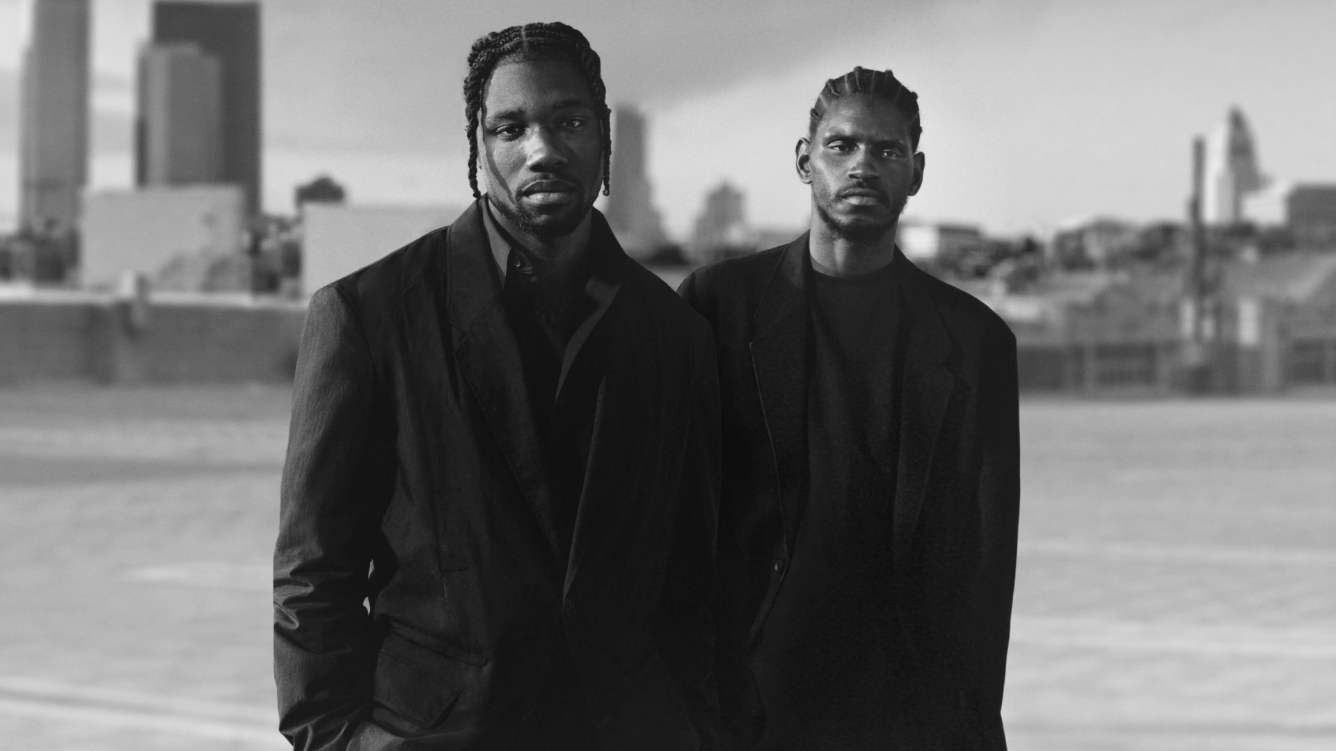 A monochromatic images depicts Noah Lyles and A$AP Nast modelling pieces from Y-3's Spring/Summer 2025 collection.