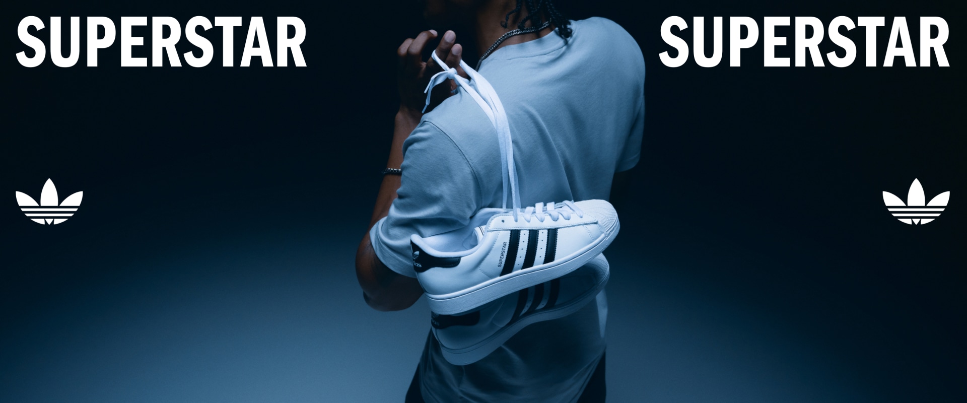 The image features a person wearing a light blue hooded sweatshirt with the word "PERSTAR" prominently displayed, standing against a dark background with the word "SUPERSTAR" visible.
