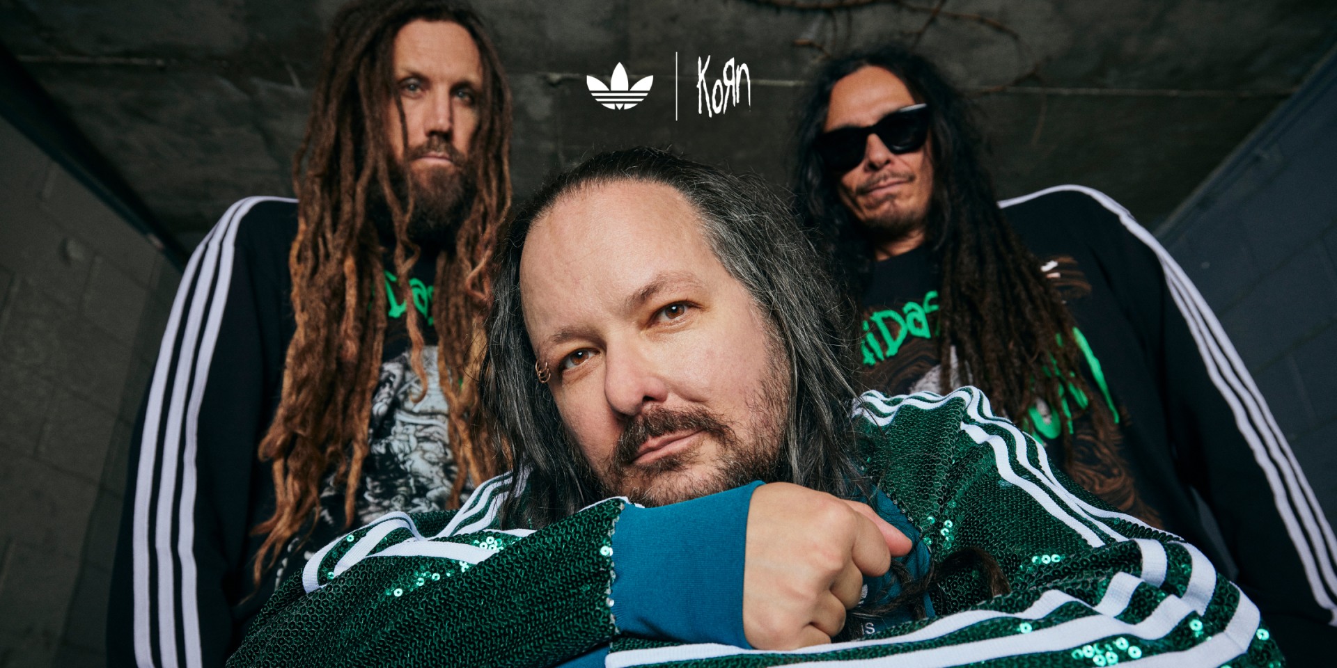 Jonathan Davis, Brian Welch (Head), and James Shaffer (Munky) posing in the adidas Originals x KoRn collection.
