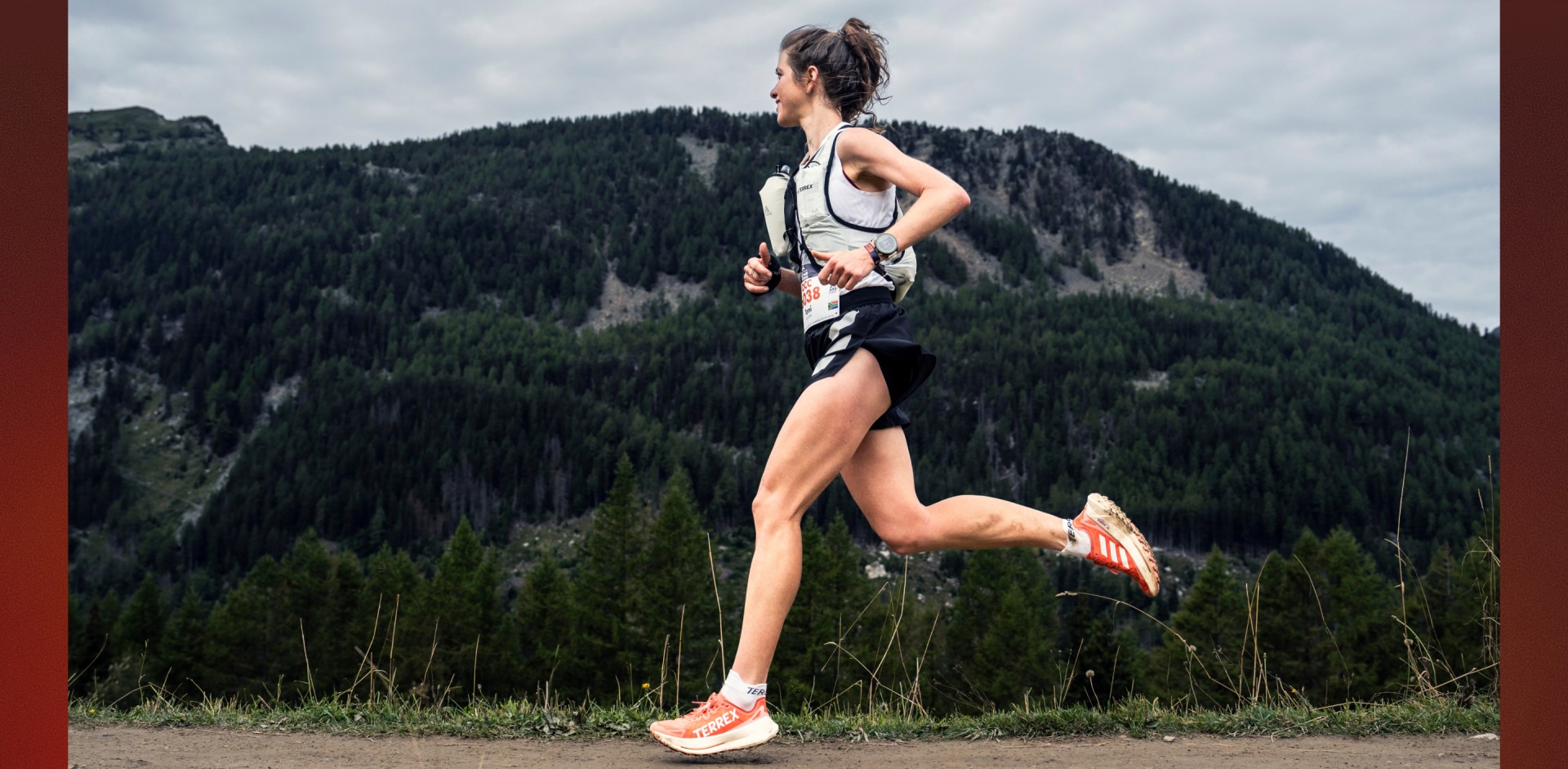 An image of adidas TERREX athlete Toni McCann, mid stride as she runs through a mountainous landscape, wearing the new Agravic Speed Ultra. 