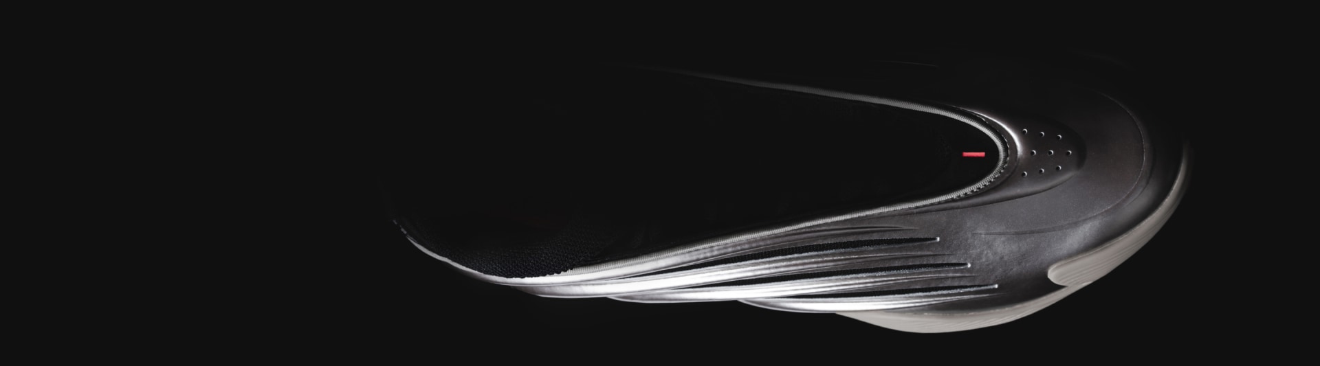 Top view of silvery basketball shoe in dark environment