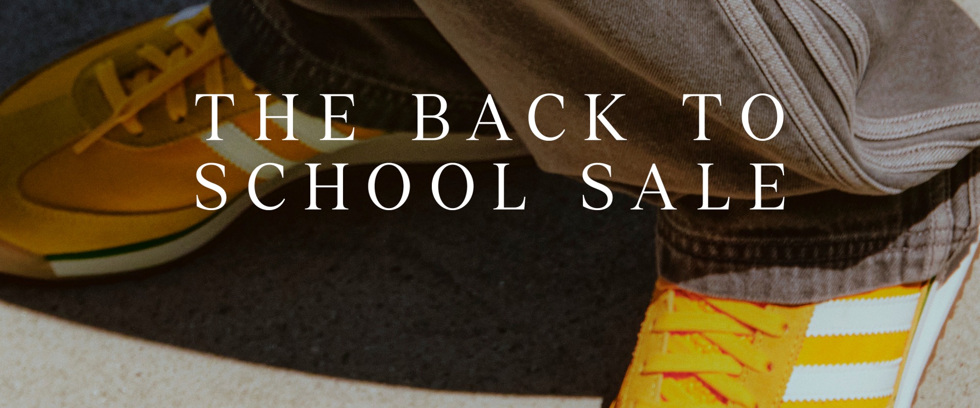 The image displays a "The Back to School Sale" sign against a backdrop of school supplies, including a backpack, pencils, and a notebook.