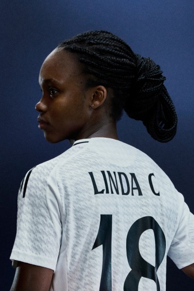 A female footballer wearing a Real Madrid Jersey