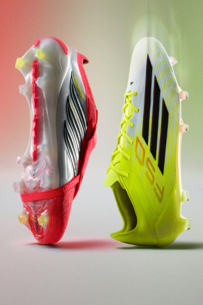 Two colorful and stylized soccer cleats are prominently displayed against a soft, gradient background.