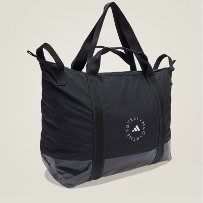 A black, rectangular tote bag with the Adidas Stella McCartney logo prominently displayed on the front.