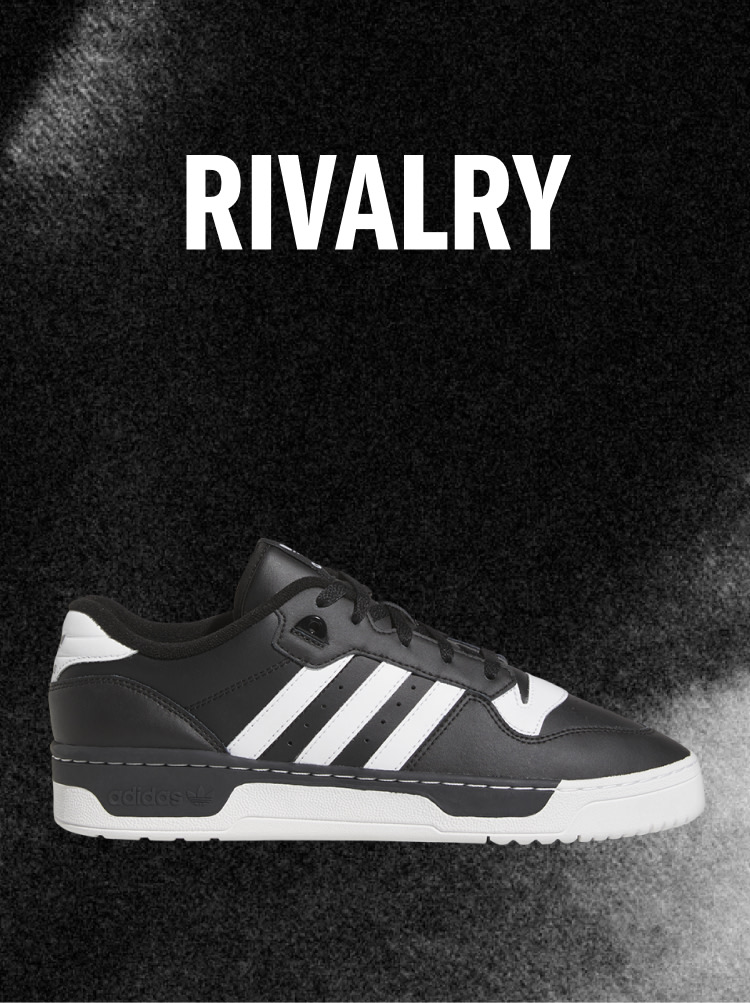 Black Adidas Rivalry sneaker with white stripes on a dark background, with the word RIVALRY above.