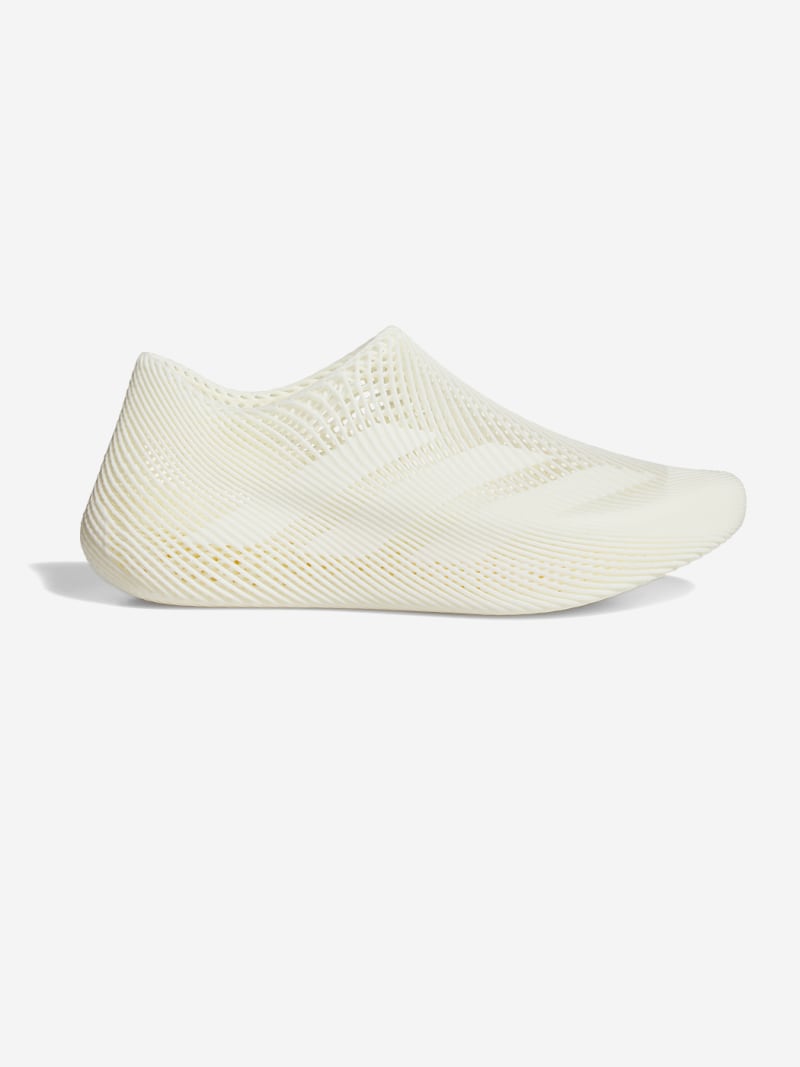 A pair of white, slip-on shoes with a perforated, mesh-like upper design against a plain, white background.