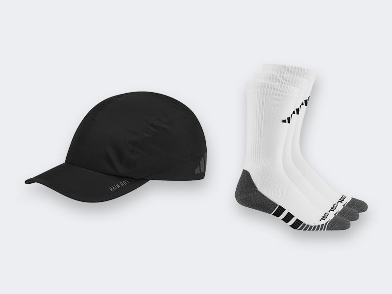 A black baseball cap and a pair of white athletic socks are displayed against a plain white background.