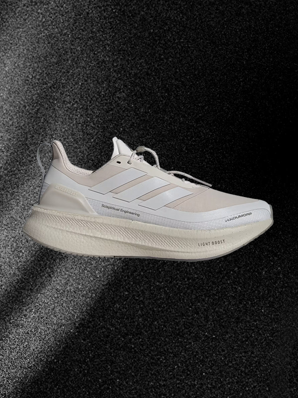 A pair of white and beige athletic shoes is prominently displayed against a dark, textured background.