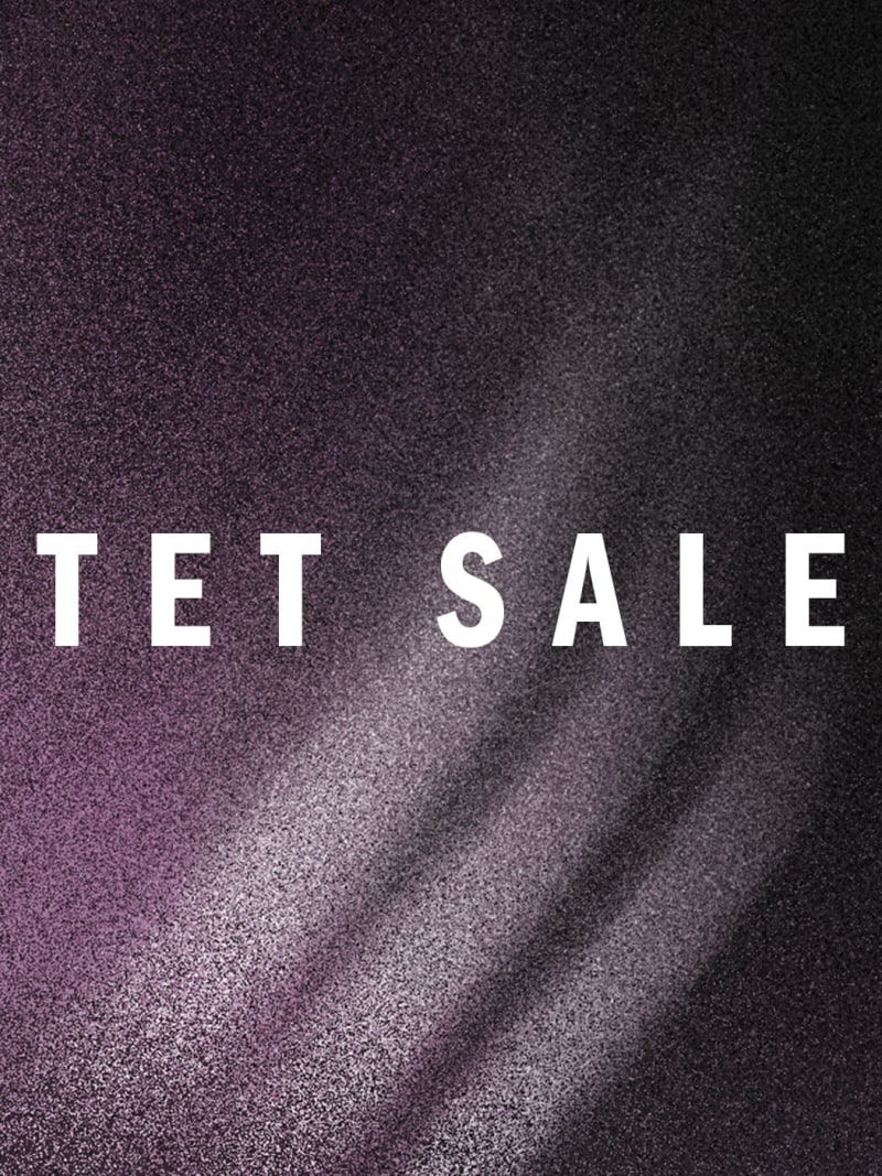 The image displays the text "TET SALE" against a dark, textured background with diagonal lines or rays of light emanating from the center.