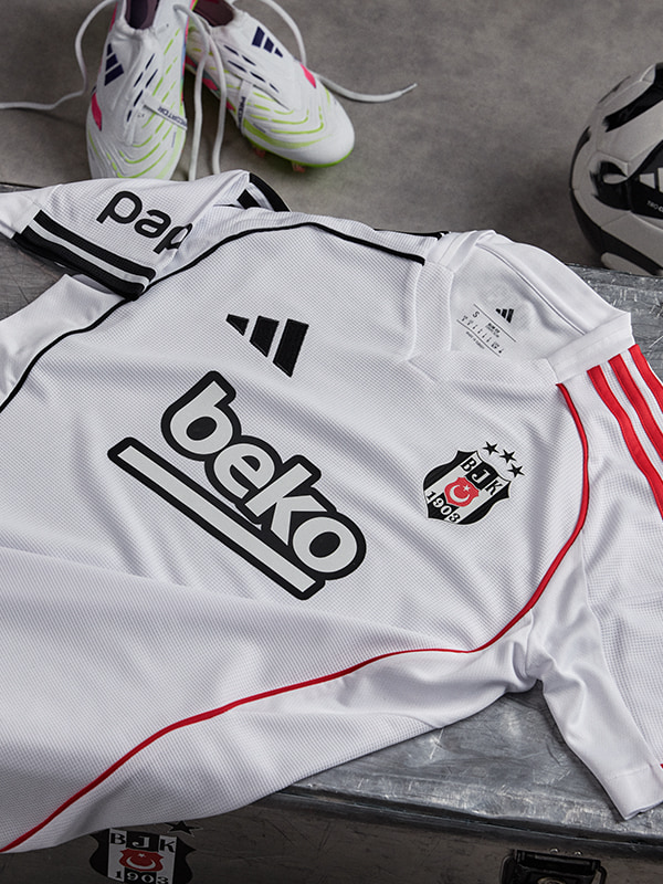 The image shows a white soccer jersey with the Beko logo, along with a pair of white and green soccer cleats and other soccer equipment.