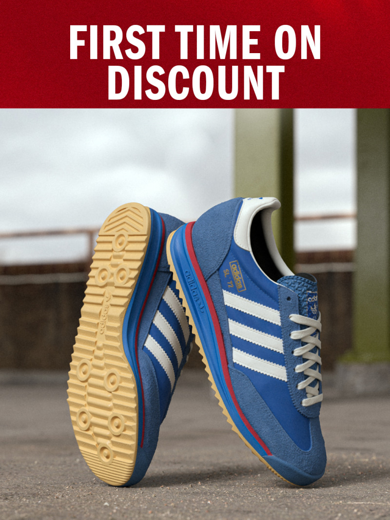 A pair of blue and white athletic shoes with red accents are displayed on a wooden floor against a red background with the text "FIRST TIME ON DISCOUNT" prominently displayed.