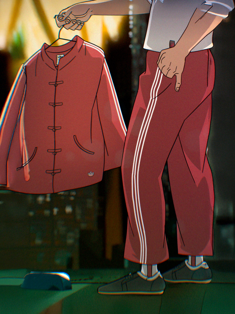 A red jacket and pants with white stripes are displayed in the foreground, with a blurred background suggesting an indoor setting.