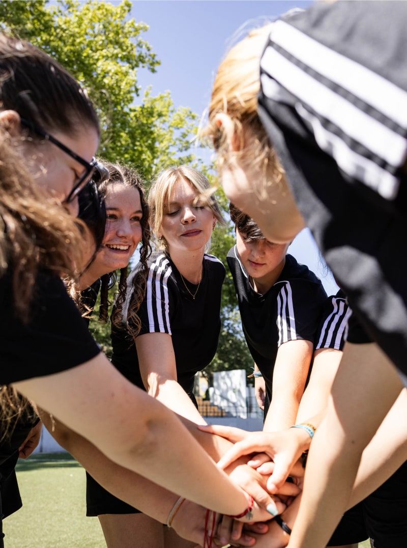 adidas-girls-sports-team-hands-together-black-sports-top