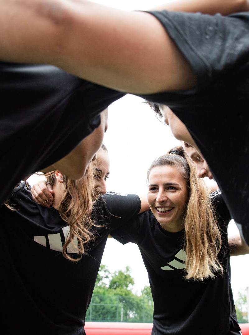 adidas-women-sports-team-huddling-black-tops