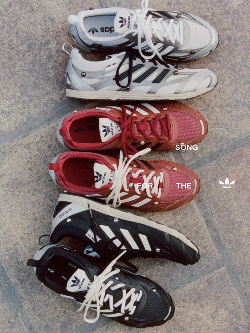 The image shows several pairs of Adidas sneakers in various colors and styles, including gray, red, and black, arranged on a gray surface.