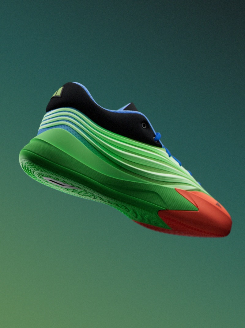 A vibrant, futuristic-looking sneaker with a sleek, curved design in shades of green, blue, and red against a solid green background.