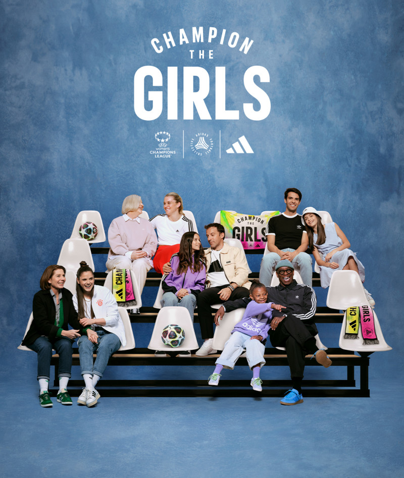 Football players sitting togther with their daughters and parents