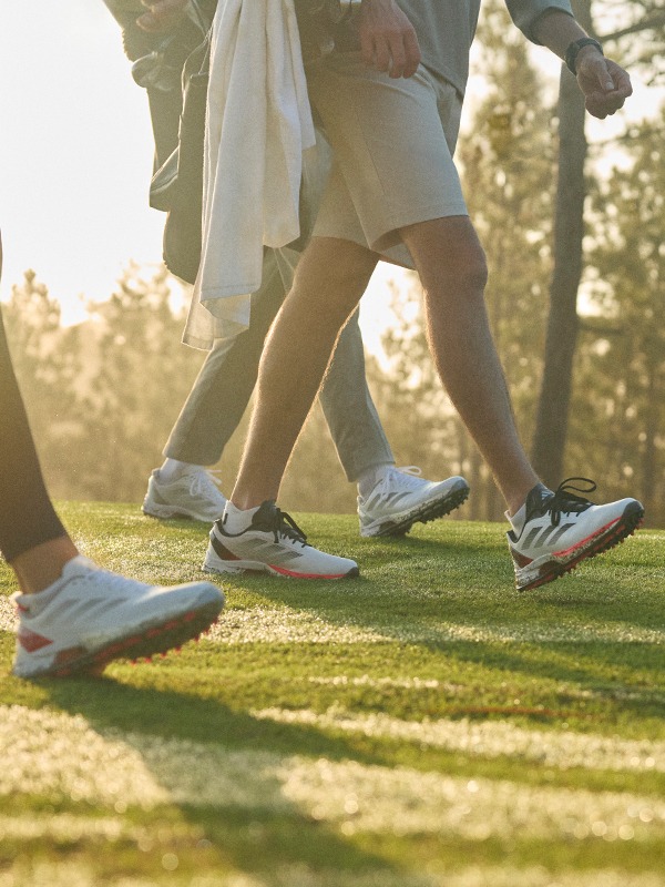 People walking in Adizero ZG golf shoes