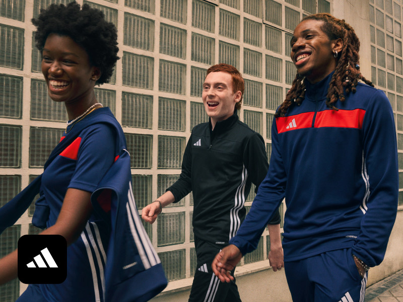 Three friends in adidas sportswear walking together.