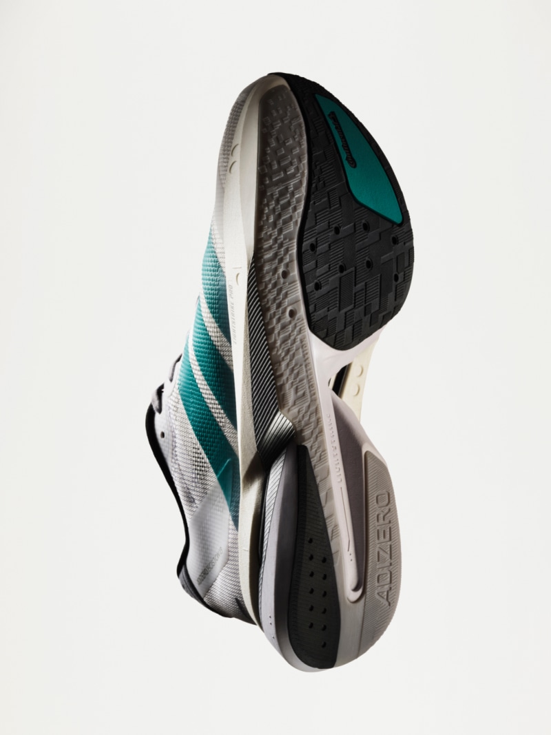 A studio shot of the new Adizero Boston 13, shown at a 45% degree angle so the sole is visible.