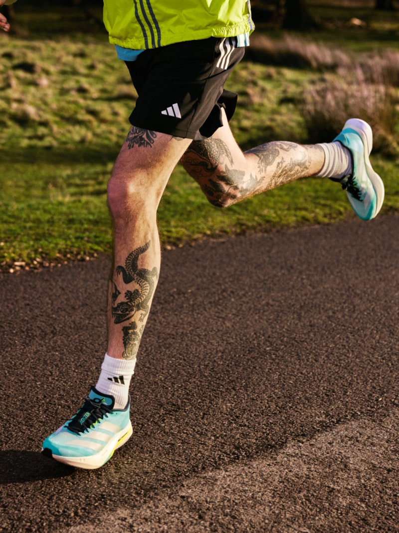 An image of man's legs running, wearing the new Adizero Boston 13s.