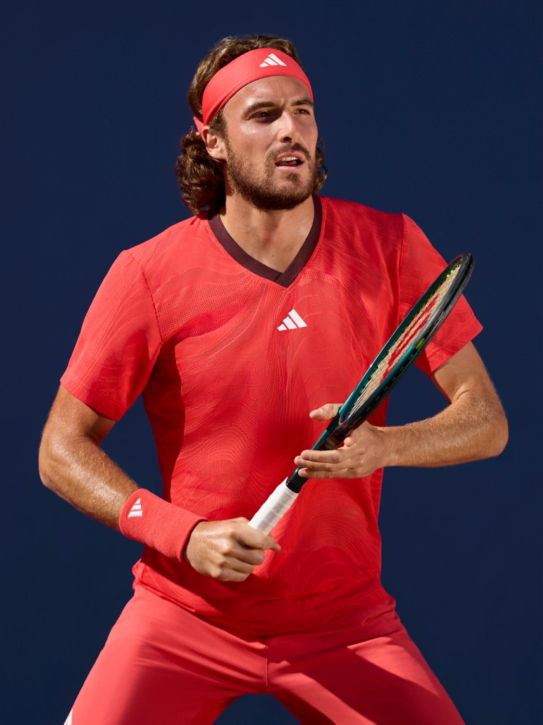 Stefanos Tsitsipas athlete wearing Melbourne Collection while playing tennis.