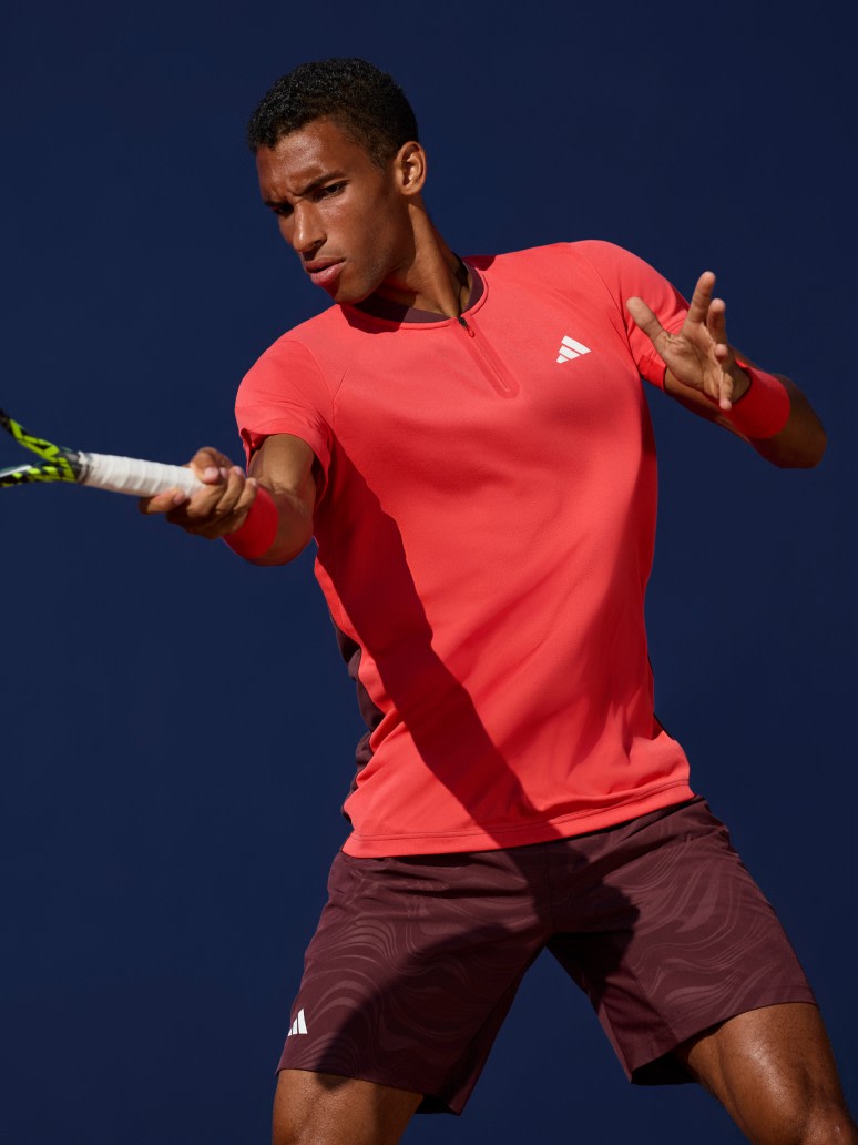 Felix Auger Aliassime athlete wearing Melbourne Collection while playing tennis.