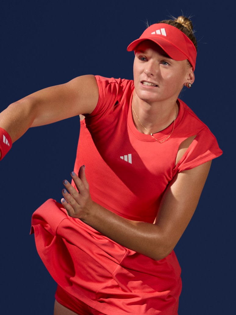 Ashlyn Krueger playing tennis, showcasing Melbourne Collection sportswear on the court.